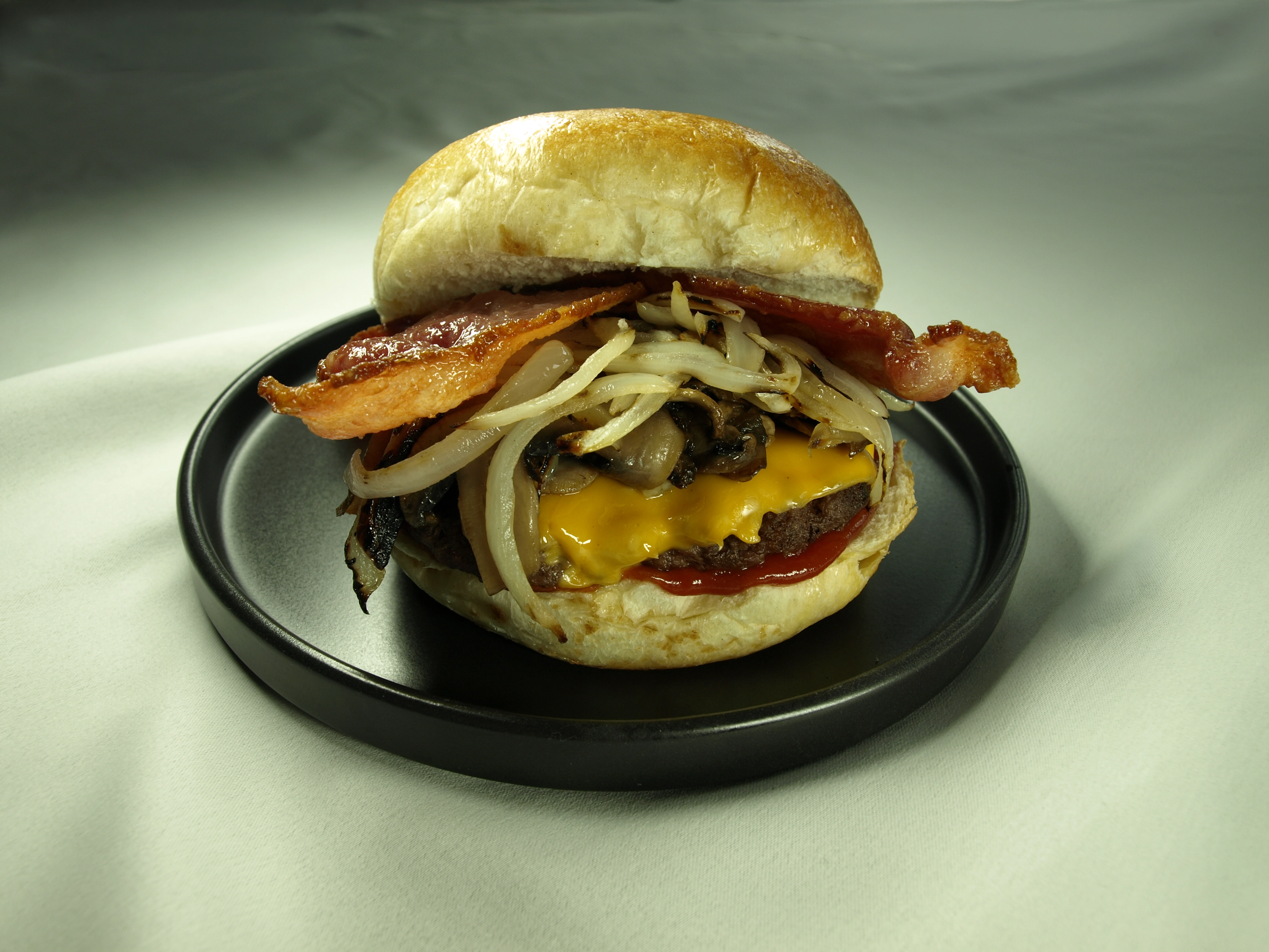 Mushroom onion bacon smash burger on a plate